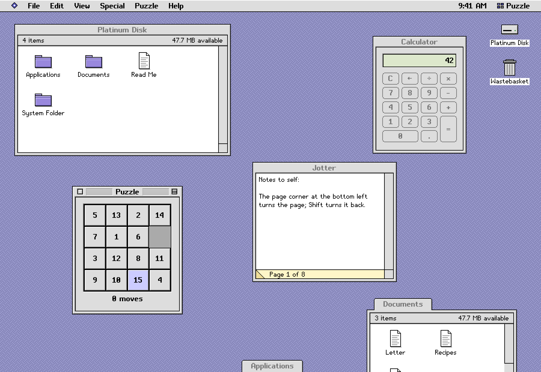 The example desktop with a few windows open: a disk, a note, a calculator and a sliding puzzle.